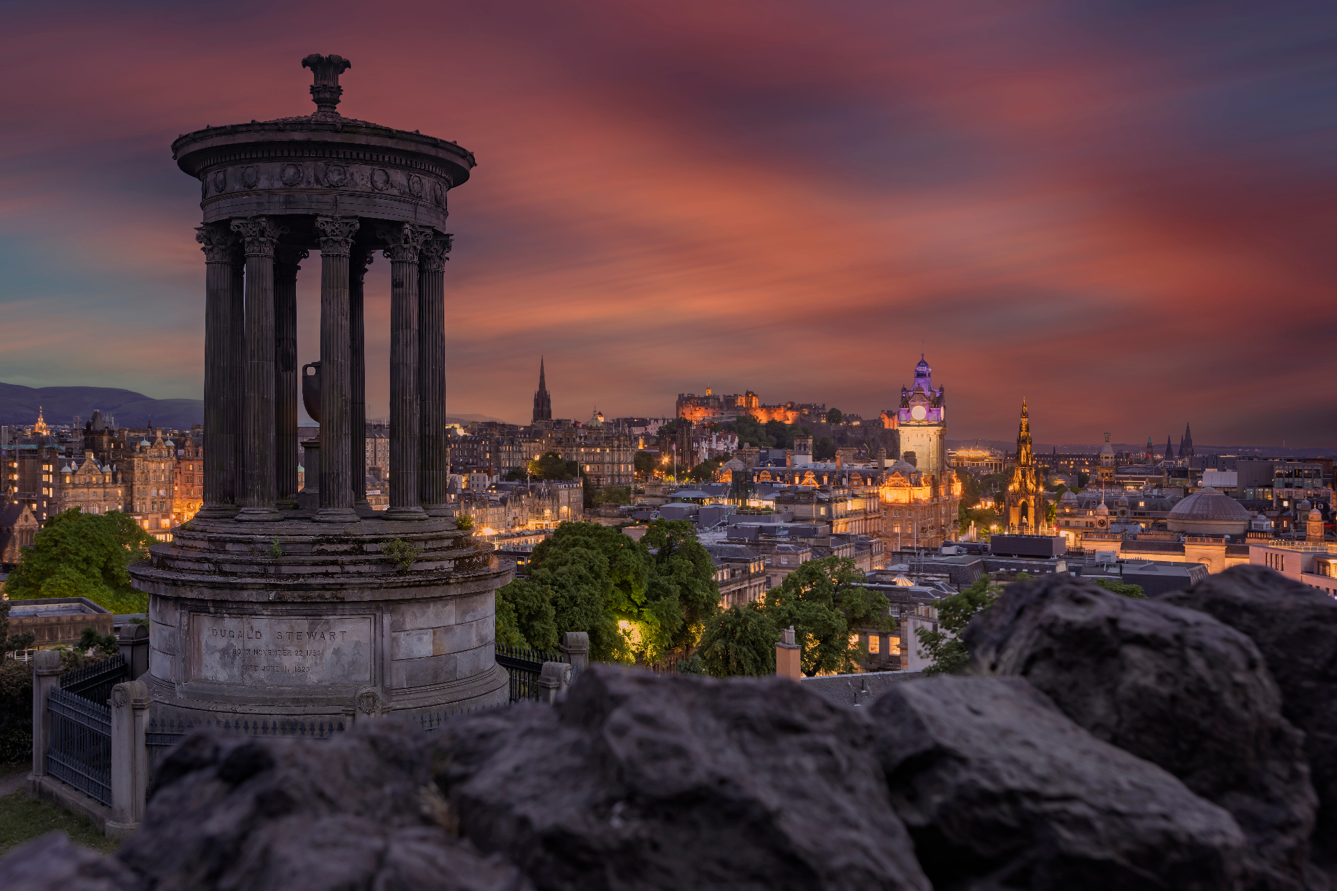 Edinburgh skyline at dusk with the castle and Balmoral clock tower seen from Calton Hill